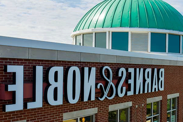 Aerial shot of a building with a green round top and the visible on the side is “Barnes and Noble”